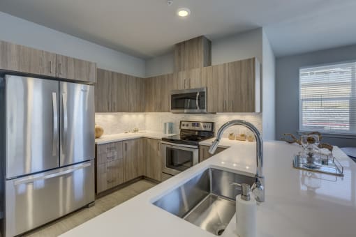 a kitchen with wooden cabinets and stainless steel appliances