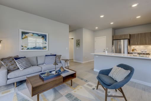 a living room with a couch chair and coffee table