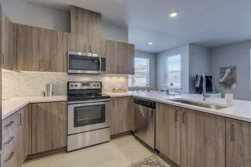 a kitchen with wooden cabinets and stainless steel appliances
