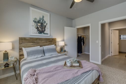 Tigard, OR Apartments for Rent - Sygnii - Bedroom with Carpet Flooring, a Spacious Closet, and a Ceiling Fan