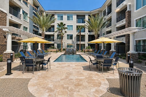 A large courtyard with a pool surrounded by apartment buildings.