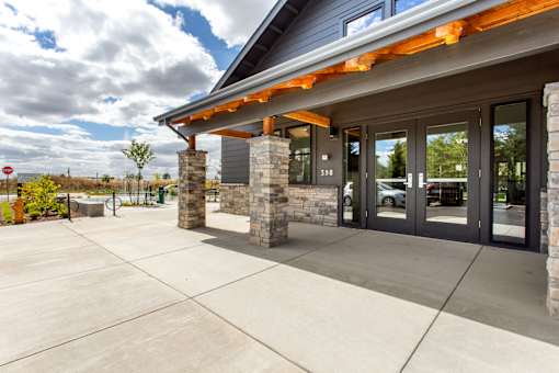 A building with a grey facade and a glass door.