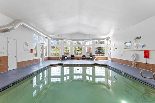 A large indoor swimming pool with a glass bottom.