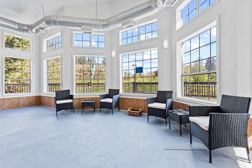 A room with a lot of windows and chairs.