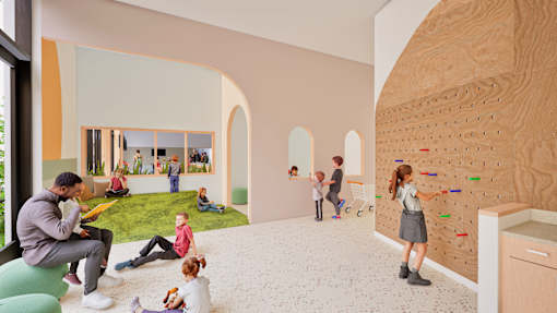 A group of children are playing in a room with a climbing wall.