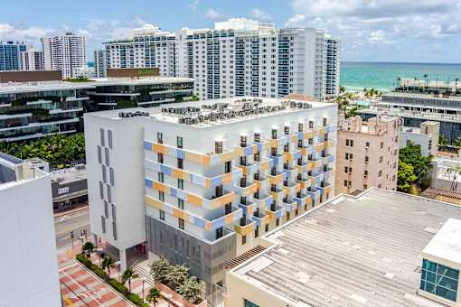 Bird’s-eye view of a Miami Beach apartment complex highlighting the urban setting and building layout.