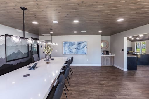 a long dining room with a long table and chairs
