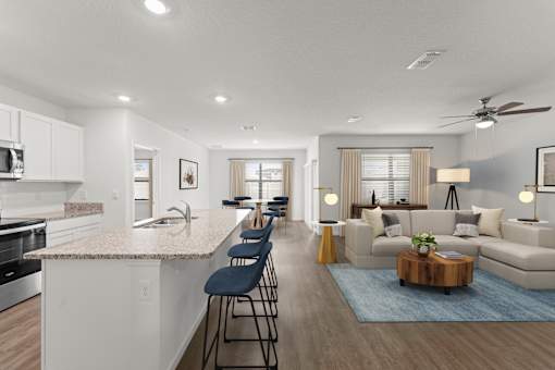 A modern kitchen with a bar area and a living room with a couch.