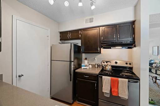 A kitchen with black appliances and wooden cabinets.