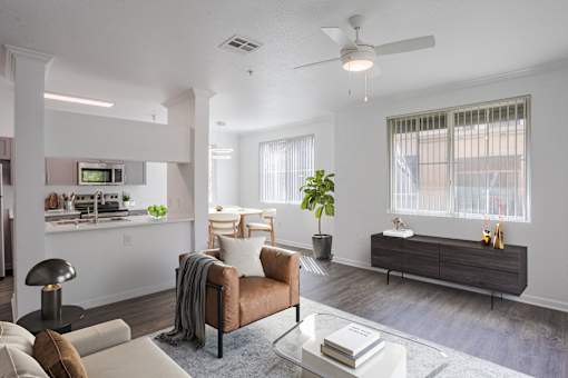 A modern living room with a brown leather couch and a glass coffee table.