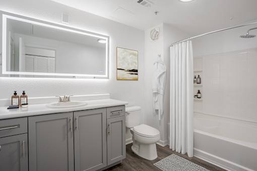 A white bathroom with a sink, toilet, and bathtub.