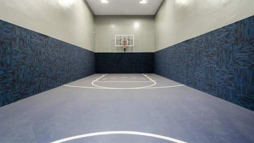 a basketball court in an empty gym