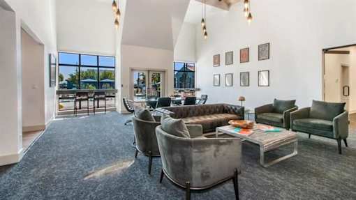 a living room filled with furniture and a large window