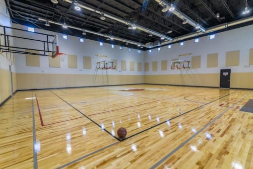 an indoor basketball court with multiple basketball hoops