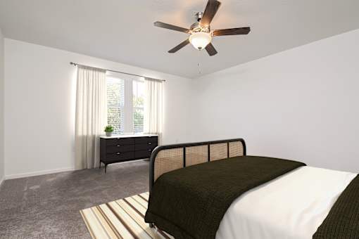 A bedroom with a bed, dresser, and window.
