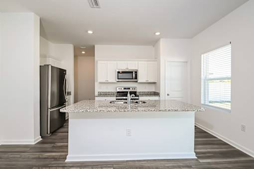 Pet Friendly Homes in Ruskin, FL - Ruskin Reserve - Gourmet Kitchen with Island Counter Open concept wood style flooring
