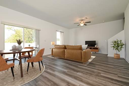 Pet Friendly Homes in Ruskin, FL - Ruskin Reserve - Living Room with wood style flooring, large windows, and ceiling fan