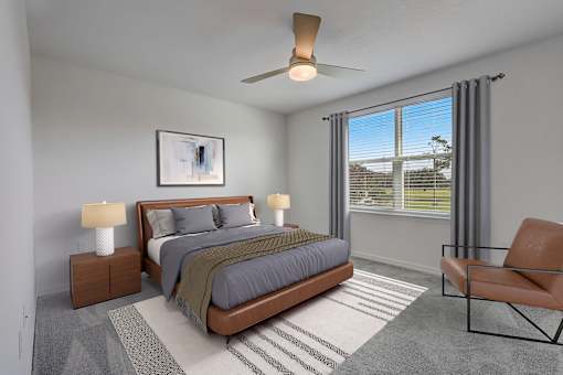 A bedroom with a bed, nightstands, and a chair.