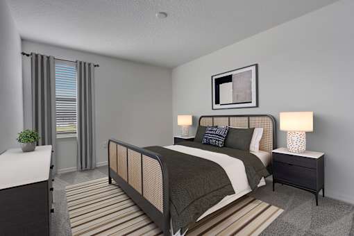A bedroom with a bed, nightstand, and a plant.