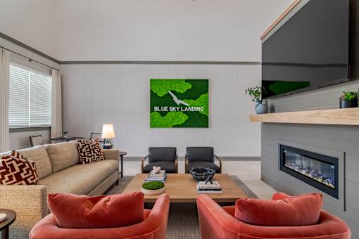 Blue Sky Landing apartments clubhouse living room with comfortable seating, fireplace and pet-friendly resident lounge near Old National Parkway in College Park, GA close to South Fulton and Hartsfield-Jackson Atlanta International Airport.