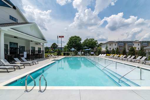 Resort-inspired community swimming pool at Blue Sky Landing apartments in College Park, GA near Hartsfield-Jackson Atlanta International Airport and Old National Parkway.