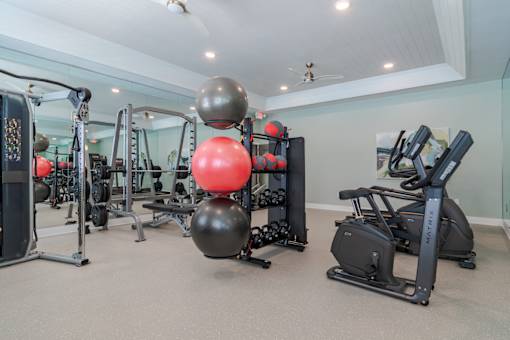 Modern resident fitness center with free weights and exercise equipment at Blue Sky Landing apartments in College Park, GA near South Fulton and Camp Creek.