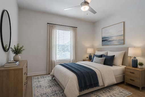 Spacious primary bedroom at Blue Sky Landing in College Park, GA featuring a ceiling fan, large windows, plush carpeting, and modern finishes in a brand-new one-, two-, and three-bedroom apartment home.