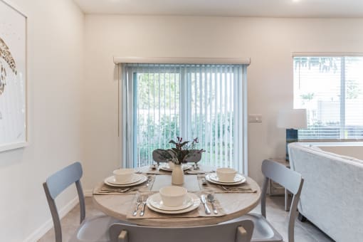 Boatman Hammock Townhomes in Lake Worth, FL photo of a dining room with a table and chairs and a window