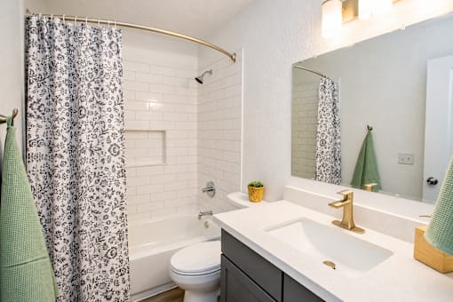 Apartment bathroom with tiled tub and shower at Haven at Lone Mountain in Las Vegas