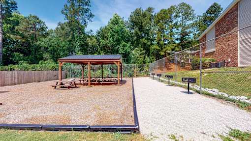 Outdoor picnic area at Broad on the Green in Augusta, GA, featuring grills and seating in a pet-friendly apartment community.