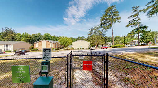Leash-free dog park at Broad on the Green in Augusta, GA, featuring open green space and play areas for pets in a pet-friendly apartment community.