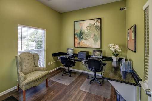 A room with a desk and chairs.