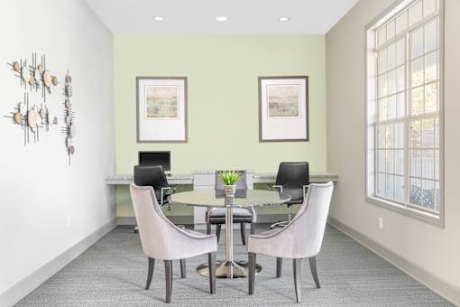 A dining room with a table and chairs.