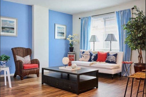 Apartments in Tustin, CA - Tustin Cottages - Living Room with Wood-Style Floors, a Large Window, and Open Floor Plan