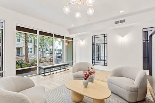 A living room with a wooden coffee table and a chandelier.