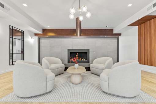 A modern living room with a fireplace and grey sofas.