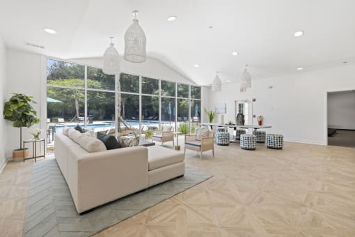 Savannah, GA Apartments – The Palms at Chatham– a clubhouse with a large window and a view of a pool