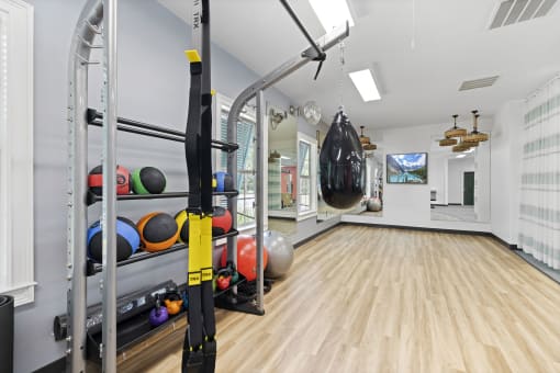 Apartments in Savannah, GA for Rent – The Palms at Chatham- a home gym with weights and a punching bag