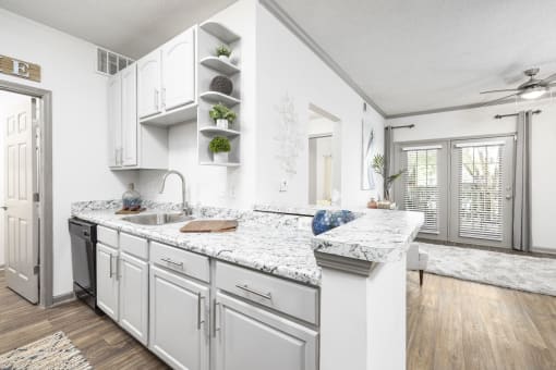 Pet-Friendly Apartments in Savannah, GA – The Palms at Chatham – a kitchen with white cabinets and granite countertops