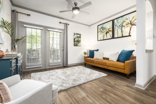 Savannah, GA Apartments – The Palms at Chatham– a living room with a ceiling fan and hardwood floors