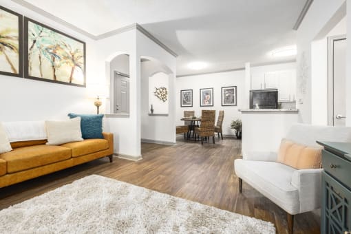 Apartments in Savannah, GA for Rent – The Palms at Chatham- a living room and dining room with white walls and hardwood floors