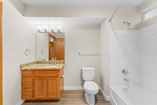 A bathroom with a sink, toilet, and bathtub.