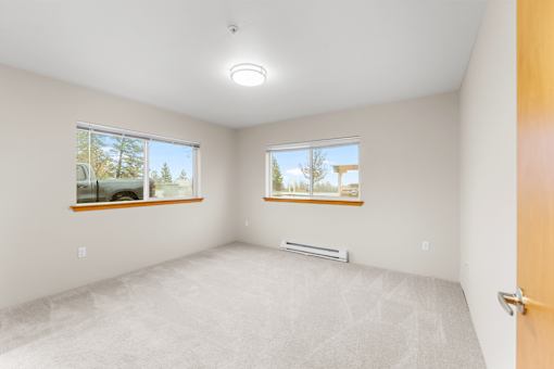 A room with a car parked outside the window.