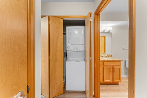 A kitchen with a white fridge and wooden cabinets.