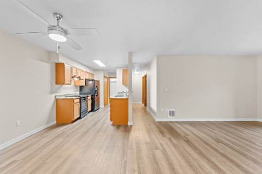 A kitchen with wooden floors and cabinets.