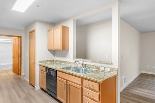 A kitchen with wooden cabinets and a granite countertop.