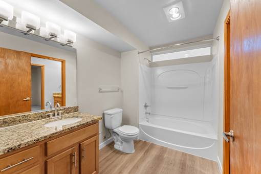 A bathroom with a toilet, sink, and bathtub.