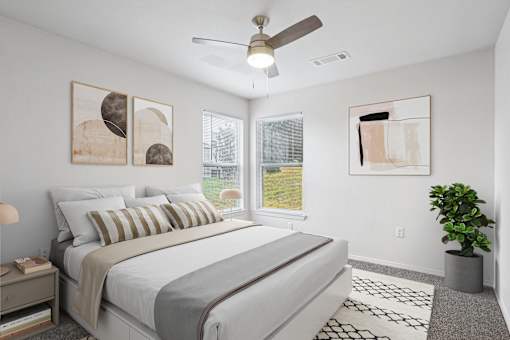 Pet-Friendly Rentals in Little Rock, AR – Capitol Hill – A bedroom with a large bed and a ceiling fan.