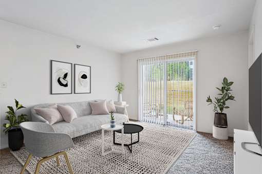 2 & 3-Bedroom Apartments for Rent in Little Rock, AR – Capitol Hill – A living room with a grey couch, a grey chair, a black and white coffee table, and a large window with blinds.