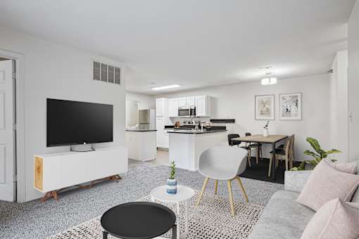 2 & 3-Bedroom Apartments for Rent in Little Rock, AR – Capitol Hill – A modern living room with a television, a dining table, and a kitchen area.